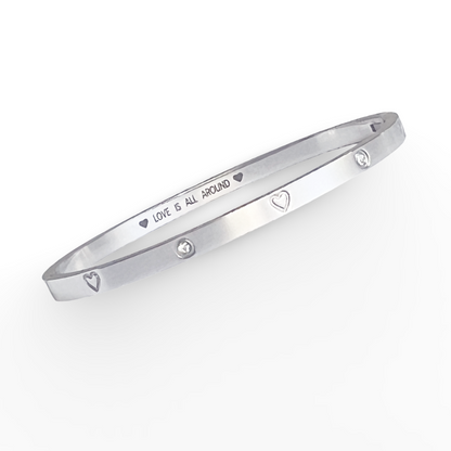 Silver bracelet with engraved text on a white background