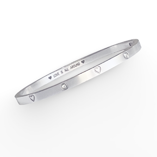 Silver bracelet with engraved text on a white background