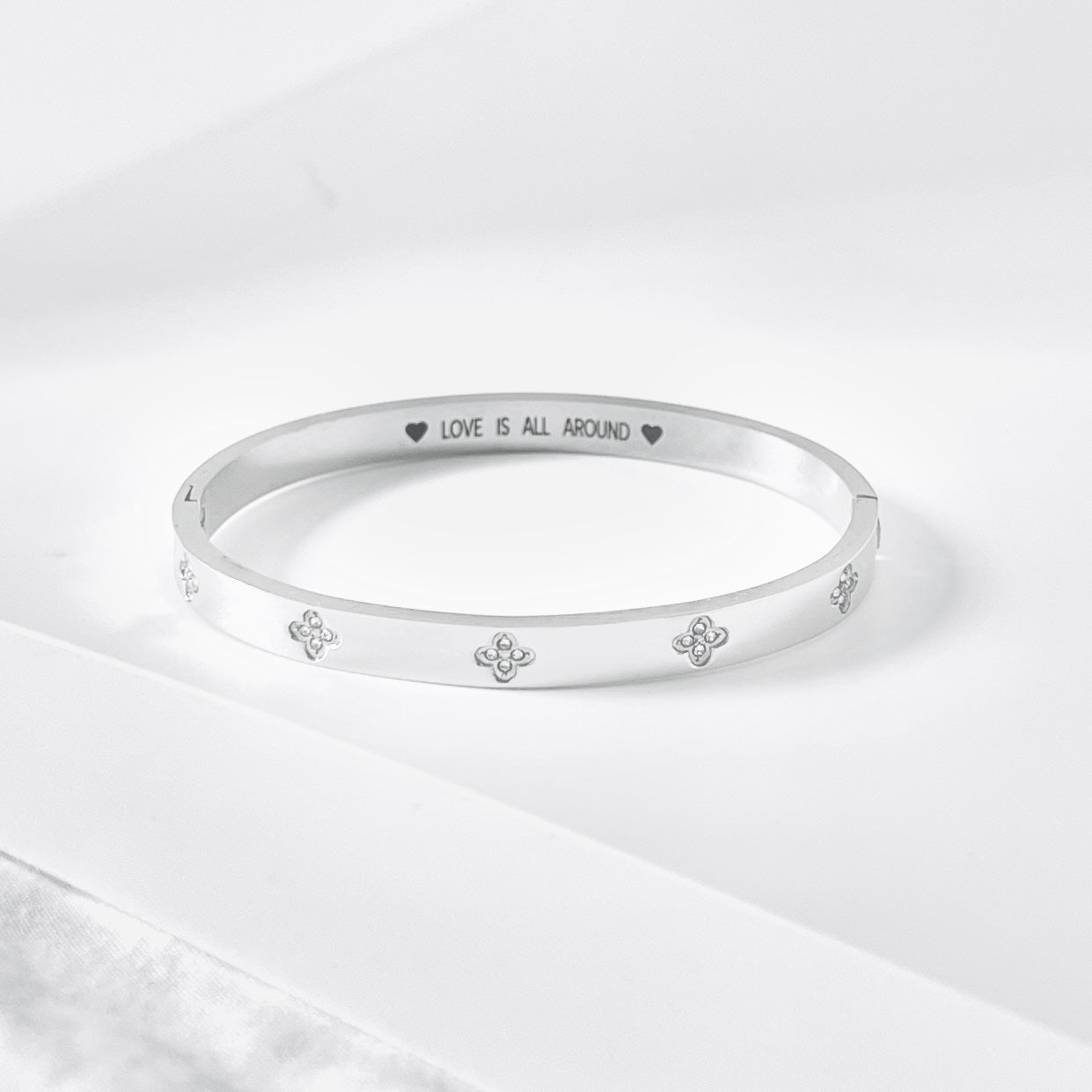 Silver Bangle with Clover Cubic Zirconia Details and “Love is All Around” Engraved Message