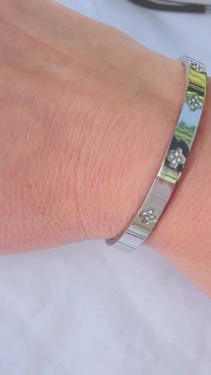 Silver Bangle with Clover Cubic Zirconia Details and 'Love is All Around' Engraved Message